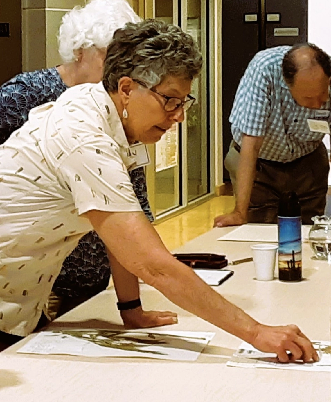 Workshop leader showing how to mount specimens